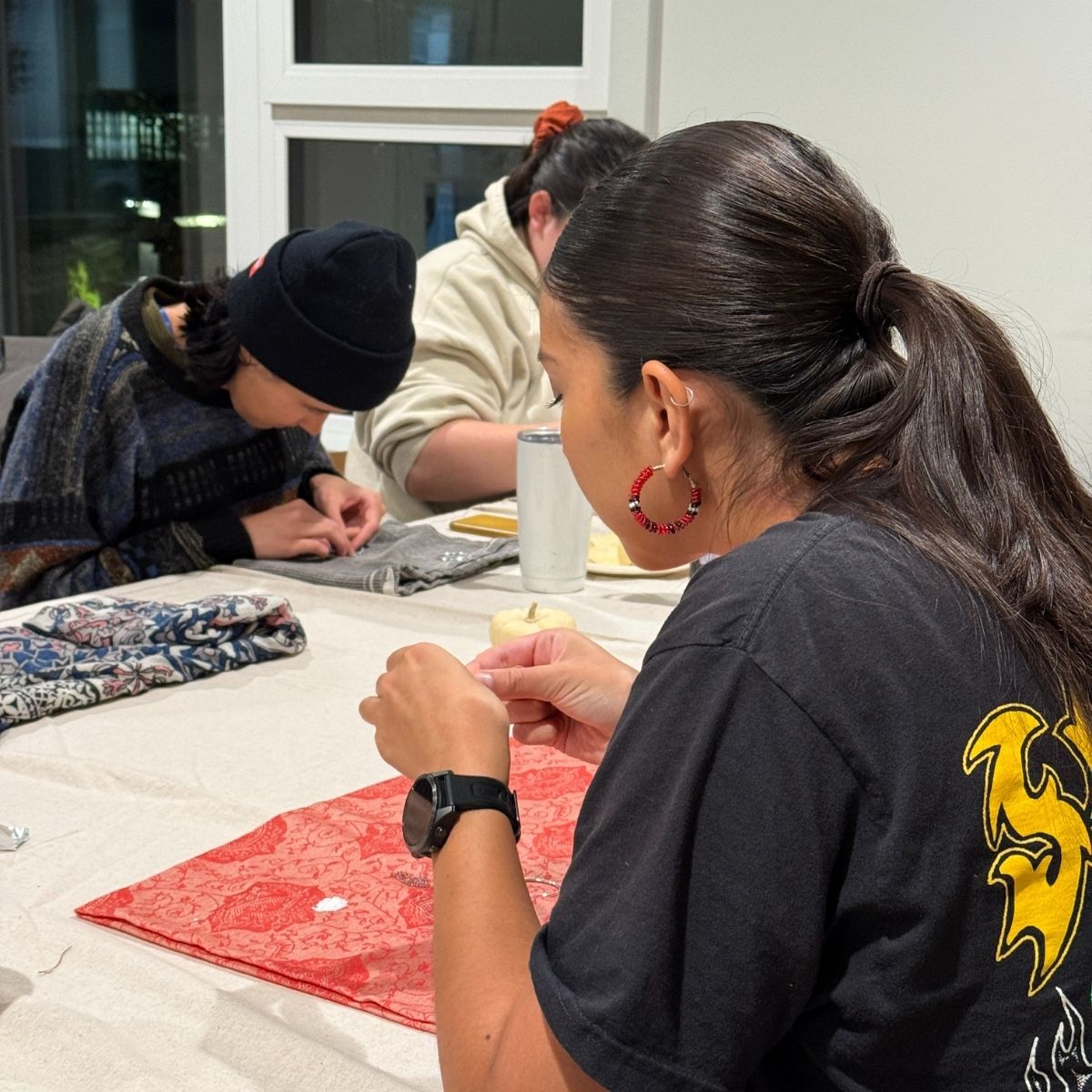 Indigenous Women Outdoors Beading Circle